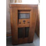 A 1950's walnut cased radiogram 102cm high, 58cm wide