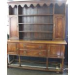 A George III style oak dresser 208cm high, 184cm wide