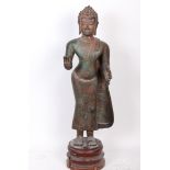 A standing bronze figure of Buddha, Vitarka mudra gesture, on wooden base 122cm high