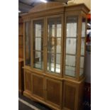 A modern glazed display cabinet 215cm high, 150cm wide