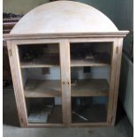 A pine glazed mirror back hanging cupboard with arched pediment, a further cupboard and Venetian