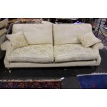 A modern three seater sofa 224cm length, together with two matching chairs