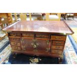 An Oriental elm coffee table with drawers 51cm high, 92cm wide