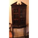 A George III style mahogany display cabinet with broken pediment and glazed upper section 67cm wide