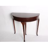 A mahogany demi lune card table on cabriole legs 84cm wide