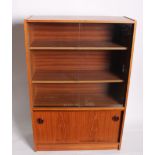 A 1970's bookcase with sliding doors 112cm high, 75cm wide