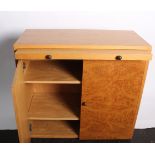 A pair of Conran dressing cabinets each with slide and burr doors enclosing shelves with ball