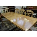 A modern extending dining table with two additional leaves and a set of eight dining chairs