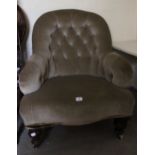 A Victorian green velvet button back upholstered armchair