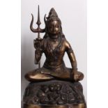 A bronze figure of Shiva seated in lotus position, holding a trident 56cm high