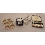 Millennium silver cased quartz clock, 6 white metal napkin rings, 2 x sets of coffee bean spoons