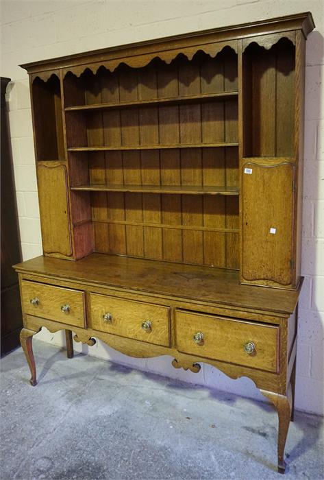 Late 19th century oak dresser, centre plate rack and side cupboards standing on a 3 drawer base