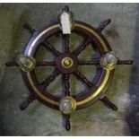 One mahogany and brass ships wheel converted into a hanging chandelier