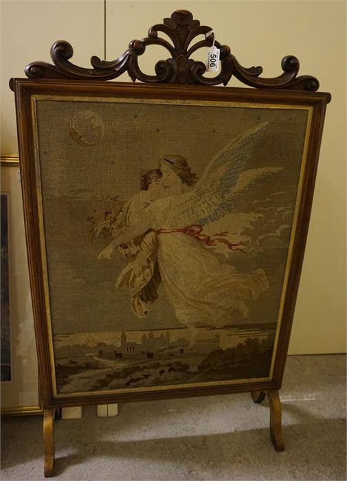 A Victorian walnut fire screen with a tapestry insert