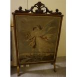 A Victorian walnut fire screen with a tapestry insert