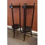 A pair of ebonised & gilt early 19th century. 2 tier stands on 3 turned supports, splayed at base.