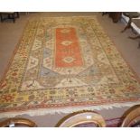 A large terracotta 9 foot by 12 foot patterned rug