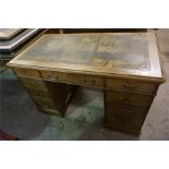 An Edwardian oak kneehole desk