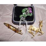 White metal enamalled thistle brooch, yellow metal bar brooch and a yellow metal deer brooch