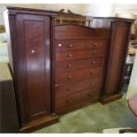 A 19th century mahogany compactum with centre drawers and side hanging cabinets