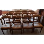 A set of 12 Victorian mahogany dining chairs covered in brown rexine