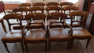 A set of 12 Victorian mahogany dining chairs covered in brown rexine