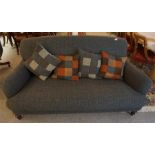 A high backed, tweed covered three seater settee, with turned mahogany feet