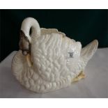 A Staffordshire pottery swan table centre piece (some restoration) 16 inches long 12 inches high