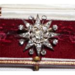 An eight ray star form Victorian diamond brooch