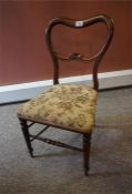 A Victorian child's chair in Rosewood with turned legs and tapestry seat