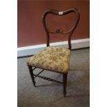 A Victorian child's chair in Rosewood with turned legs and tapestry seat