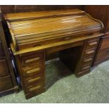 A late 19th Century Oak 'C' top roll top desk, 4 drawers either side with writing slides either side