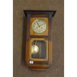 Edwardian Wall clock in a walnut stained case, spring movement.