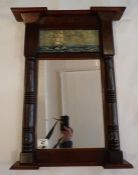 A Victorian wall mirror in mahogany with half column sides and a painted seascape