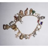 A gold link charm bracelet with 20 assorted charms