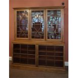 A pine bookcase with glazed doors