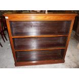 A late 19th early 20th Century open mahogany bookcase, shelved.