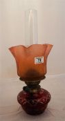 A late Victorian table oil lamp, ruby cut Boheomia glass and a etched crimped top