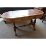 A Victorian walnut library table/desk with leather inserts.