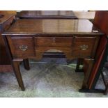 An oak hall table with 3 drawers with brass pulls.