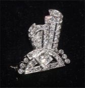 An early 20th century diamond brooch of scrolling