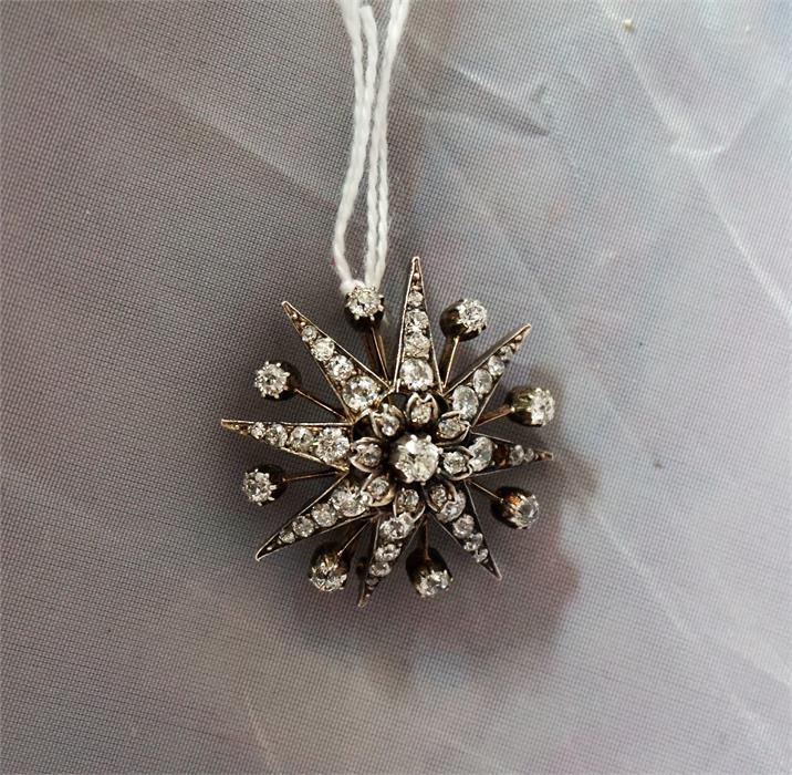 A 19th century yellow gold star burst diamond set brooch, (one small diamond missing)