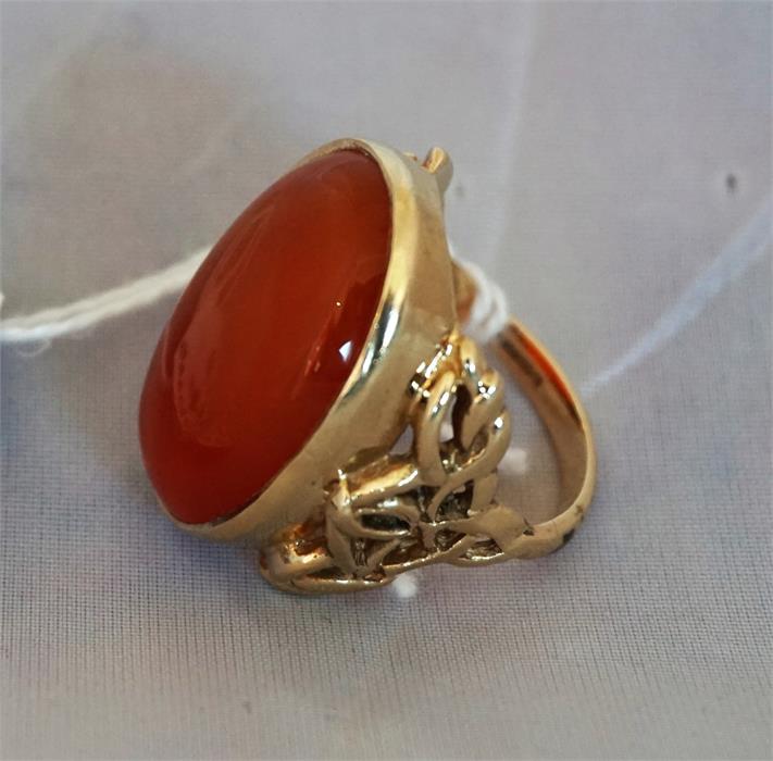 A Ladies gold dress ring set with a large Cornelian, the ring having pierced decorative sides. - Image 2 of 2