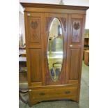An Edwardian stained Ash mirrored door wardrobe, with single drawer to base