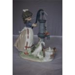 A Lladro porcelain figure group of a girl and birds at water pump