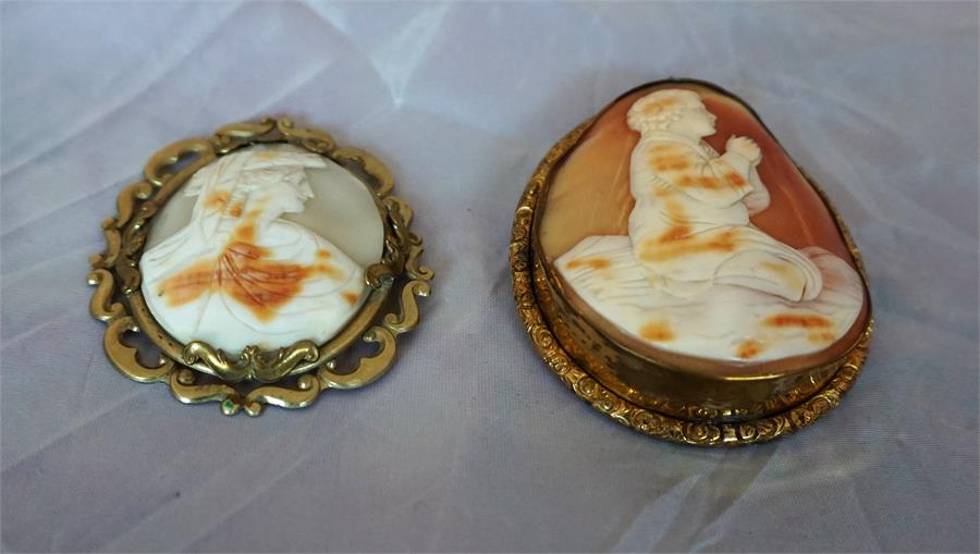 Two Victorian cameo brooches, one a female bust and the other a figure praying 6cm and 8cm high