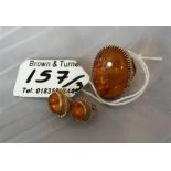 A ladies gold dress ring, set with a large amber coloured stone plus a pair amber of earrings, (3)