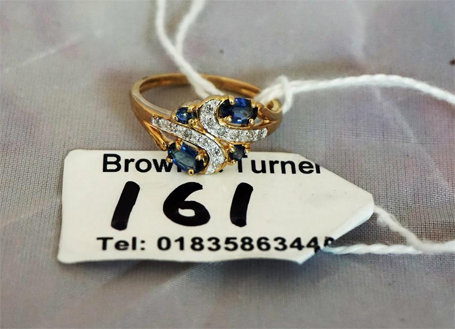 A ladies diamond and sapphire dress ring set in yellow gold