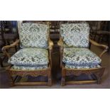 A pair of Arts and Crafts style oak cottage style arm chairs