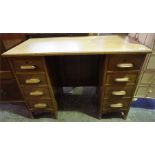 An Edwardian Oak kneehole desk, with 8 drawers